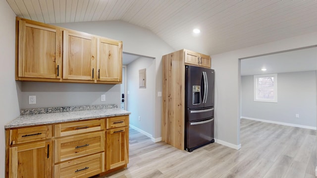 kitchen with light wood-type flooring, baseboards, lofted ceiling, and black fridge with ice dispenser