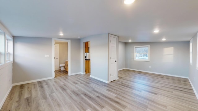 spare room with light wood-style flooring, baseboards, and recessed lighting