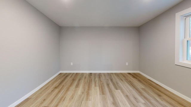 unfurnished room featuring light wood-style flooring and baseboards