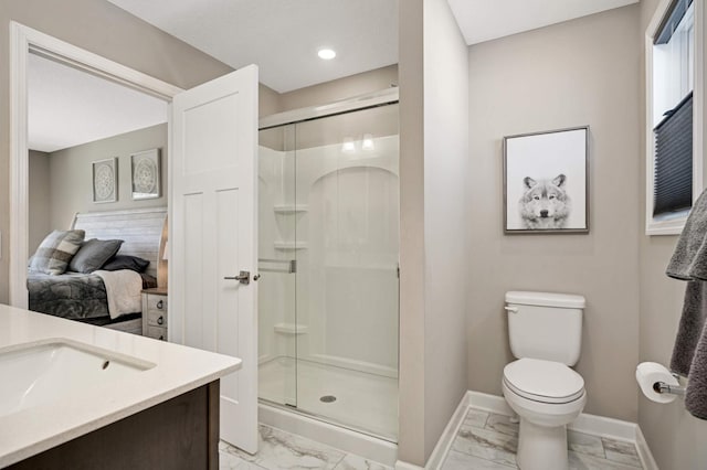 bathroom with an enclosed shower, vanity, and toilet