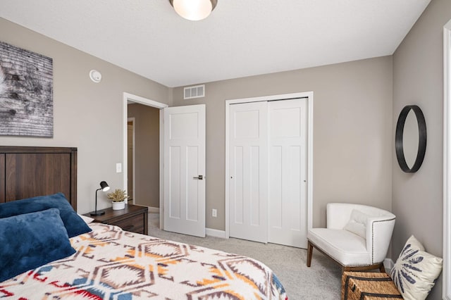 bedroom featuring light carpet and a closet