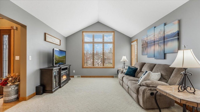 carpeted living area featuring lofted ceiling, visible vents, and baseboards