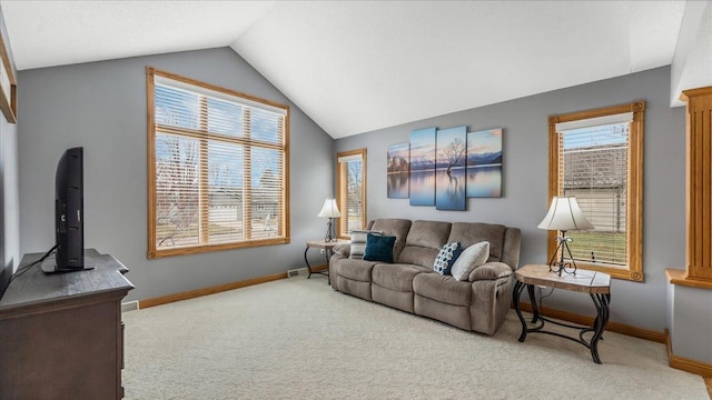 living area with carpet floors, vaulted ceiling, and baseboards