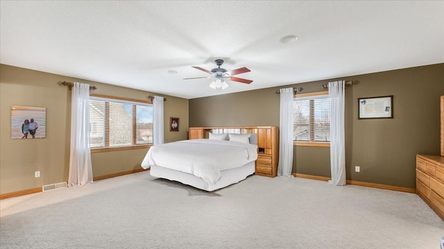 bedroom featuring light carpet, multiple windows, and visible vents