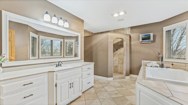 bathroom with tile patterned flooring, a garden tub, vanity, and walk in shower