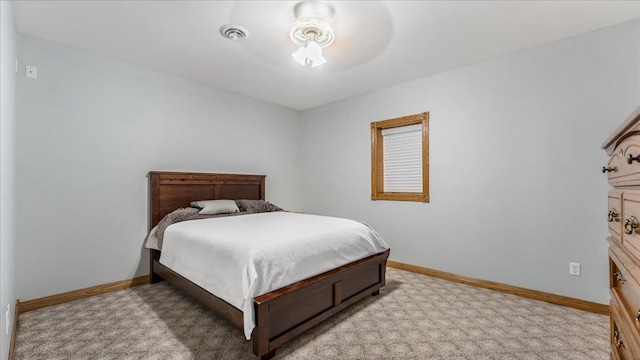 bedroom featuring visible vents, baseboards, and light colored carpet