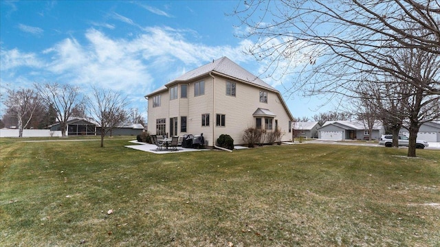 view of property exterior featuring a patio area, a detached garage, and a yard