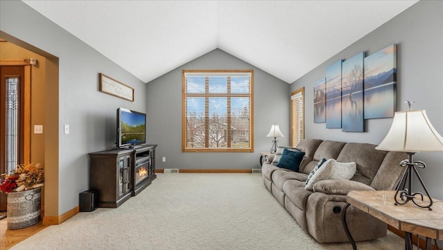 carpeted living area with visible vents, baseboards, and vaulted ceiling