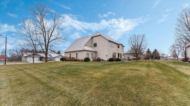 view of side of home with a lawn