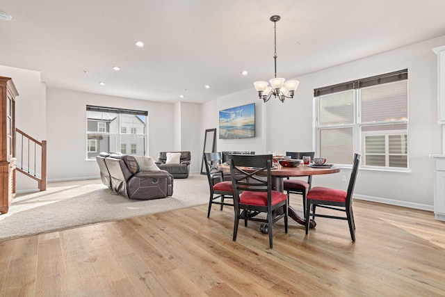 dining space featuring a notable chandelier and light hardwood / wood-style flooring