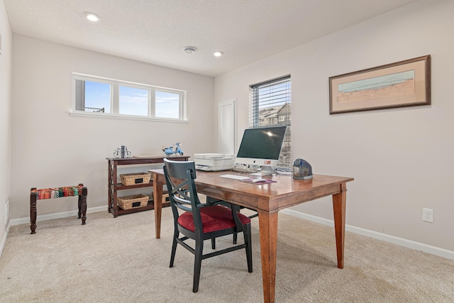 home office featuring light carpet and a textured ceiling