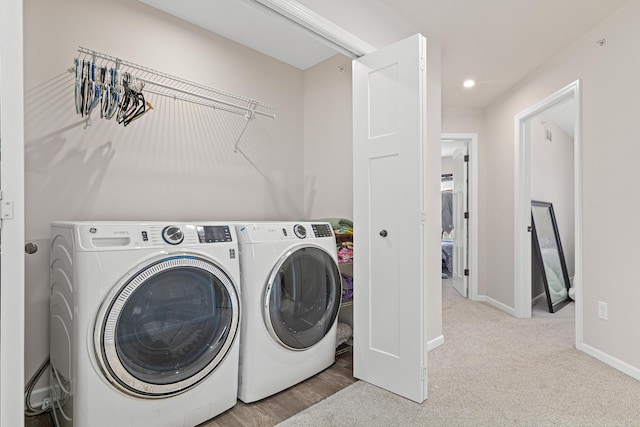 laundry room with light carpet and independent washer and dryer