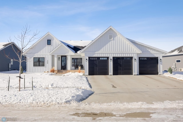 modern farmhouse style home with a garage, board and batten siding, and concrete driveway