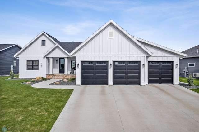 modern farmhouse with a garage, a front lawn, board and batten siding, and driveway