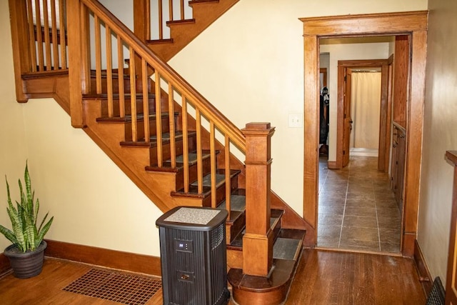 staircase with hardwood / wood-style flooring