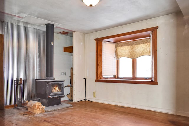 living room featuring a wood stove and hardwood / wood-style flooring