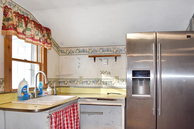 kitchen featuring sink, dishwasher, and stainless steel refrigerator with ice dispenser