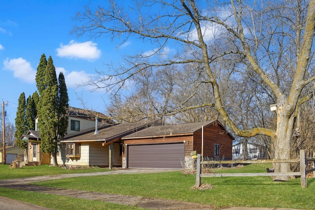 view of front facade with fence, roof with shingles, a garage, a front yard, and driveway