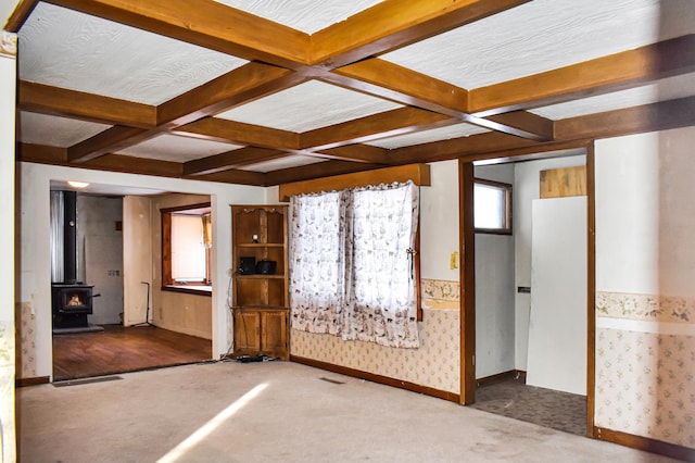 unfurnished living room with beam ceiling, carpet, and coffered ceiling