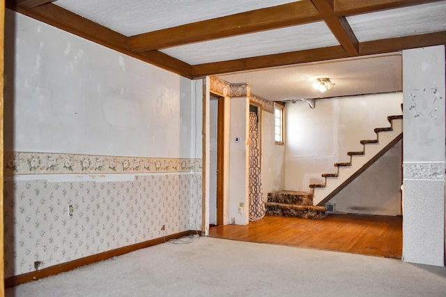 basement with carpet flooring, stairway, and wallpapered walls