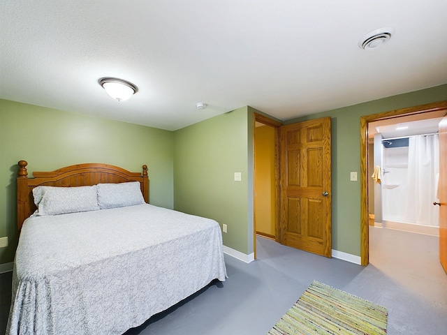 bedroom with visible vents, finished concrete flooring, and baseboards