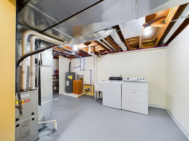 unfinished below grade area with washing machine and dryer, water heater, baseboards, and a sink