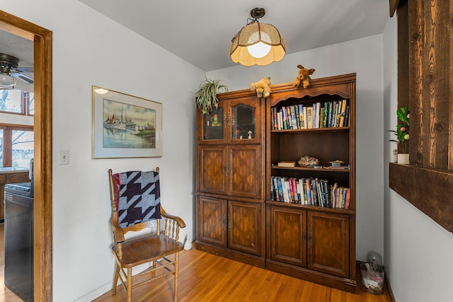 sitting room featuring light wood-style floors and ceiling fan