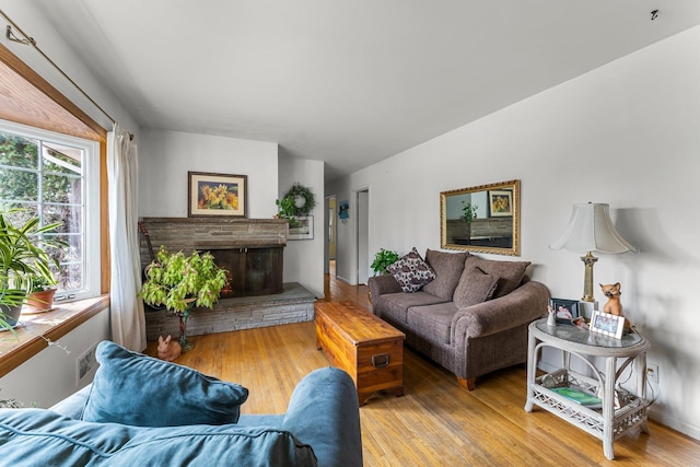 living area with a fireplace and hardwood / wood-style flooring