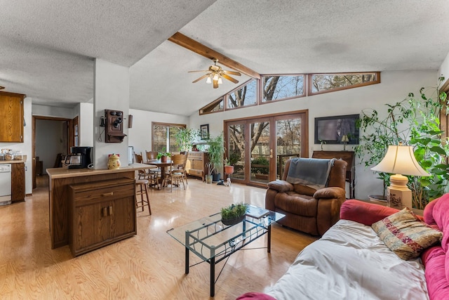 living room with light wood-style flooring, a textured ceiling, vaulted ceiling with beams, and ceiling fan