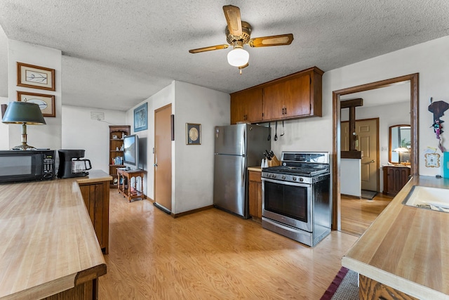 kitchen featuring light wood-style floors, appliances with stainless steel finishes, and light countertops