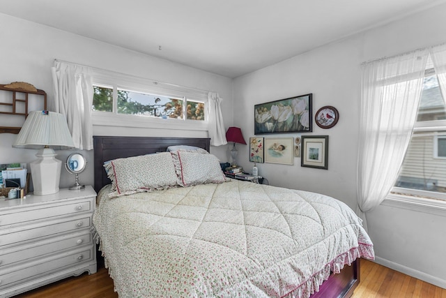 bedroom featuring baseboards and wood finished floors