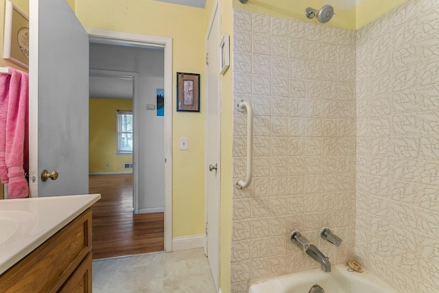 full bath featuring vanity, bathing tub / shower combination, baseboards, and tile patterned floors