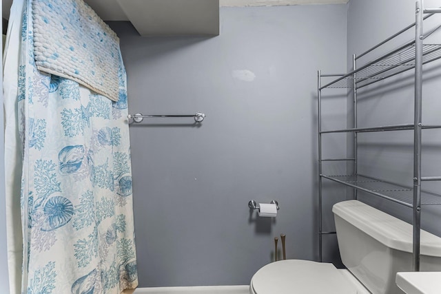 bathroom with a shower with curtain and toilet