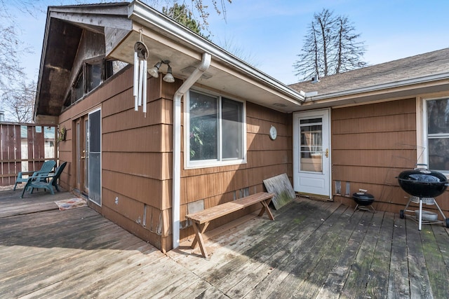 wooden deck featuring a grill