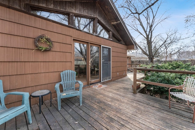 wooden terrace featuring fence