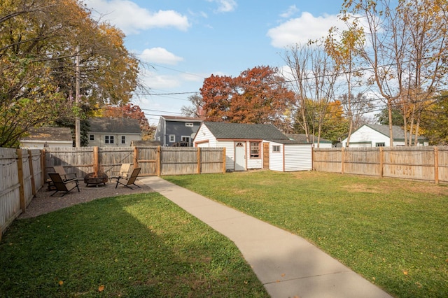 view of yard with a fire pit and an outbuilding