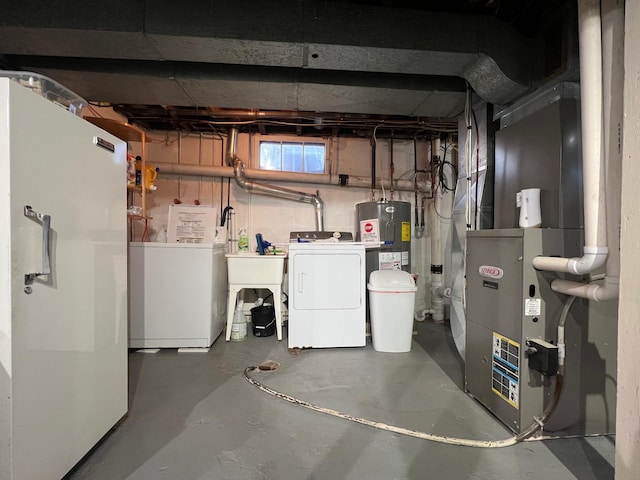 basement with electric water heater, heating unit, sink, and separate washer and dryer