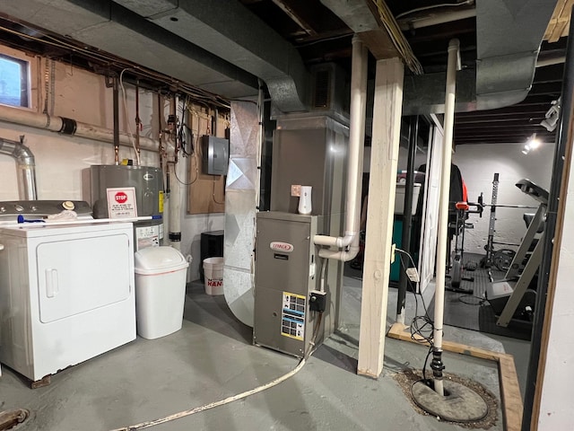 basement featuring heating unit, washer / clothes dryer, and water heater