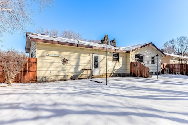 view of snow covered rear of property