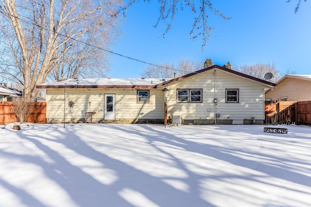 view of snow covered rear of property