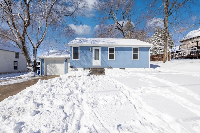 view of front of house featuring a garage and fence