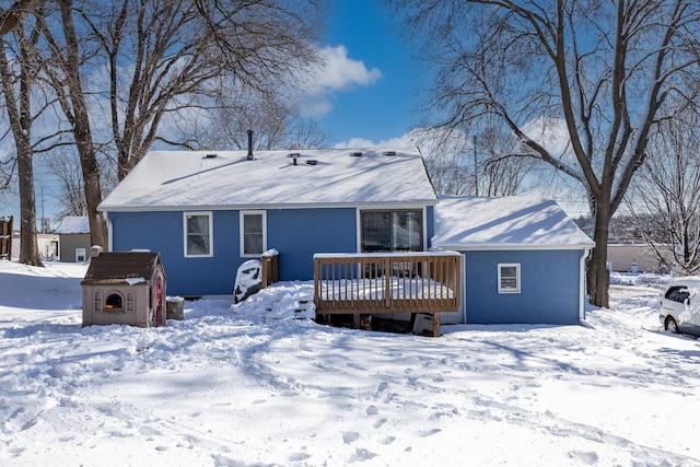 snow covered property featuring a wooden deck