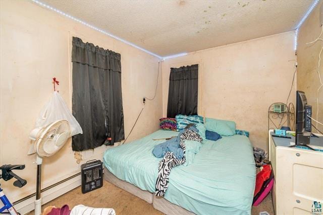 bedroom with a baseboard heating unit