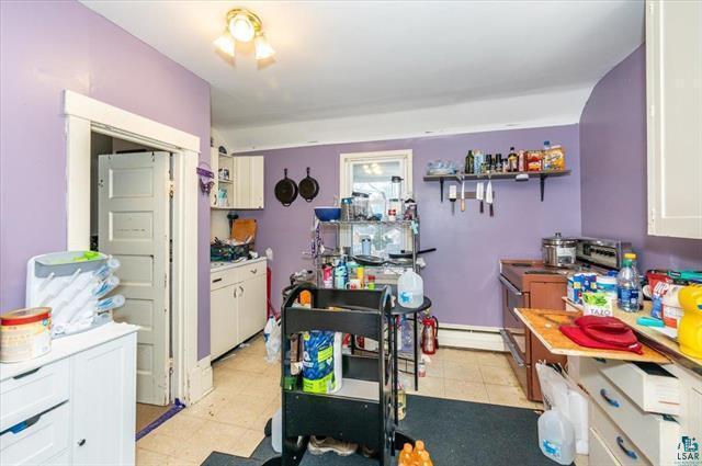 kitchen featuring electric range and white cabinets