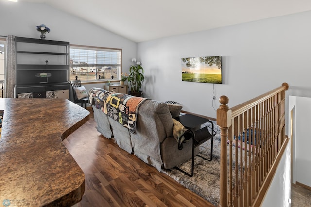 living room featuring vaulted ceiling and wood finished floors