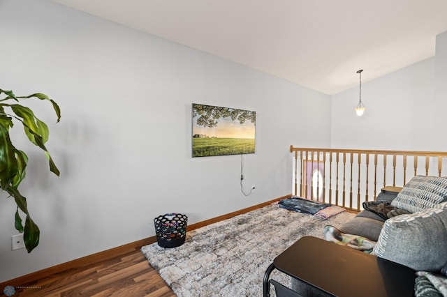 living room with lofted ceiling, baseboards, and wood finished floors