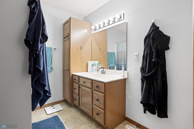 bathroom with vanity and baseboards