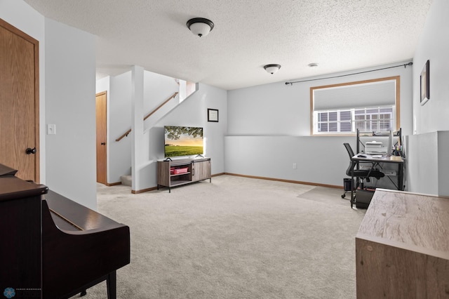 home office with a textured ceiling, baseboards, and light colored carpet