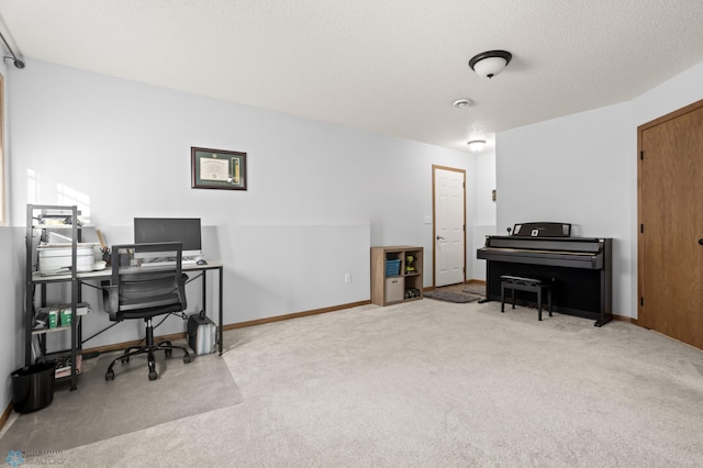 office with a textured ceiling, carpet, and baseboards