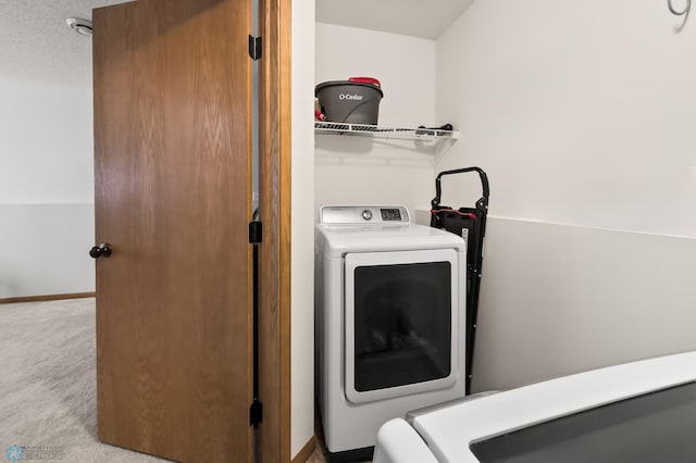 laundry area featuring laundry area, carpet, and baseboards